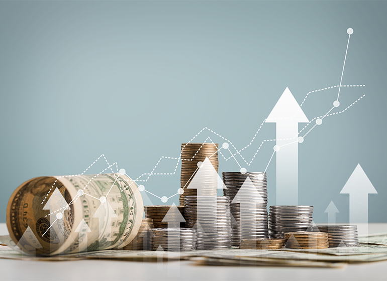 stack of coins with trading chart in investment growth