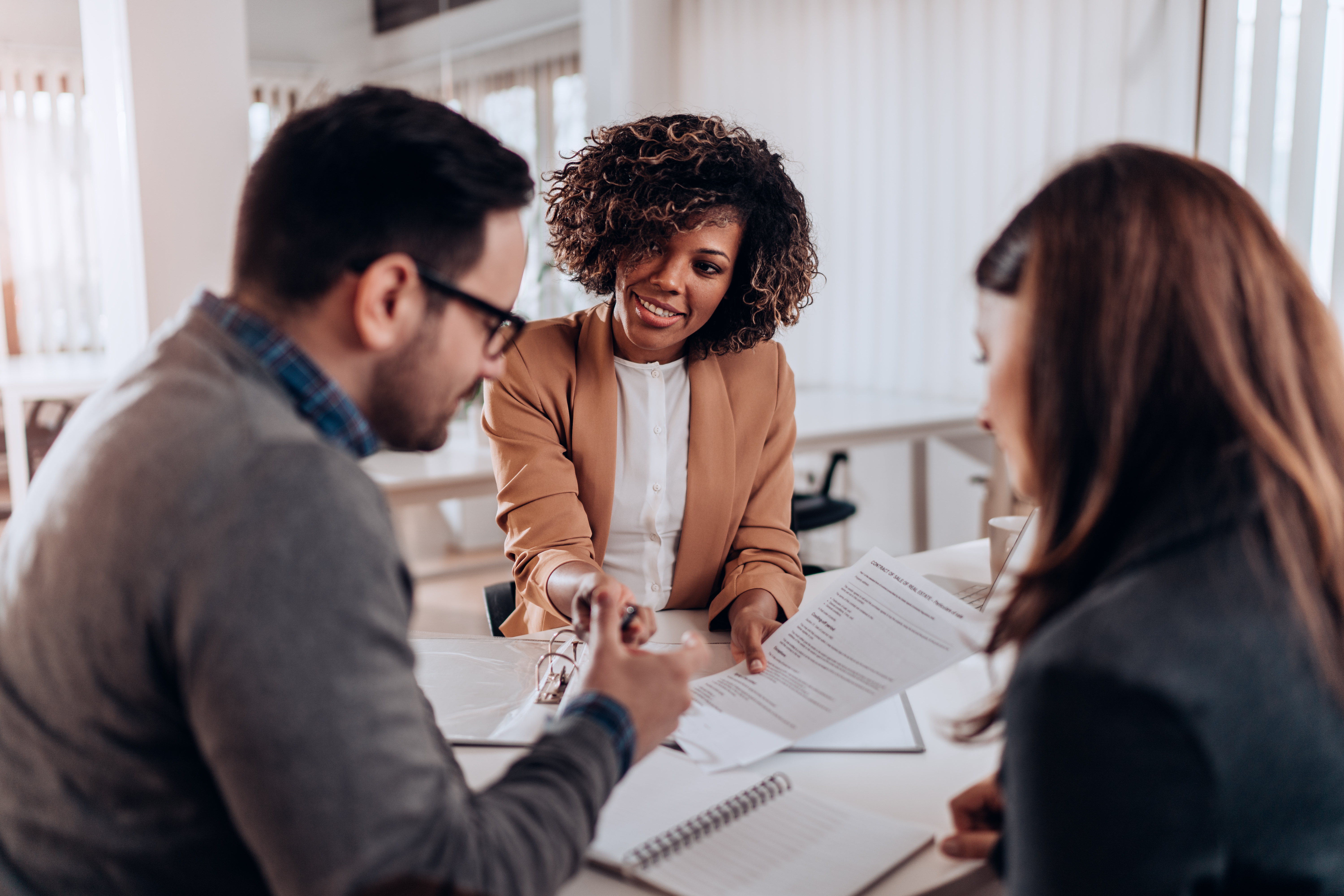 Couple signing loan agreement at the bank