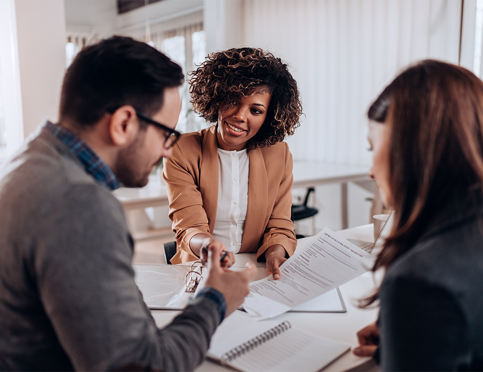 Couple signing loan agreement at the bank